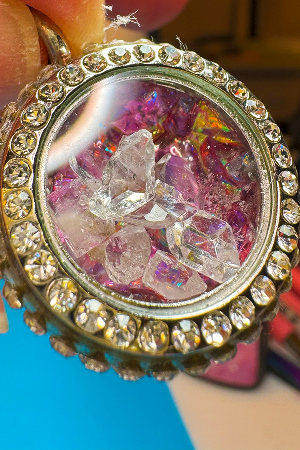 A Locket with a Red Flower background filled with sparkly Gems