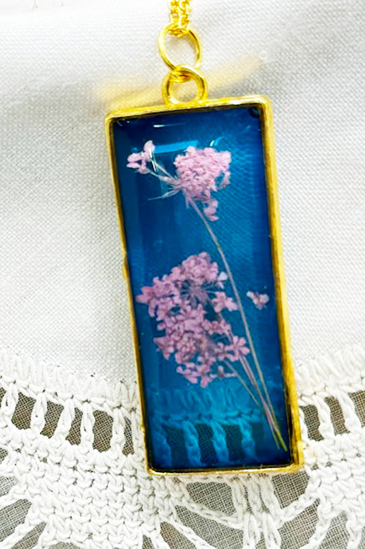 Blue Resin Necklace with Pink Flowers in Gold Rectangle