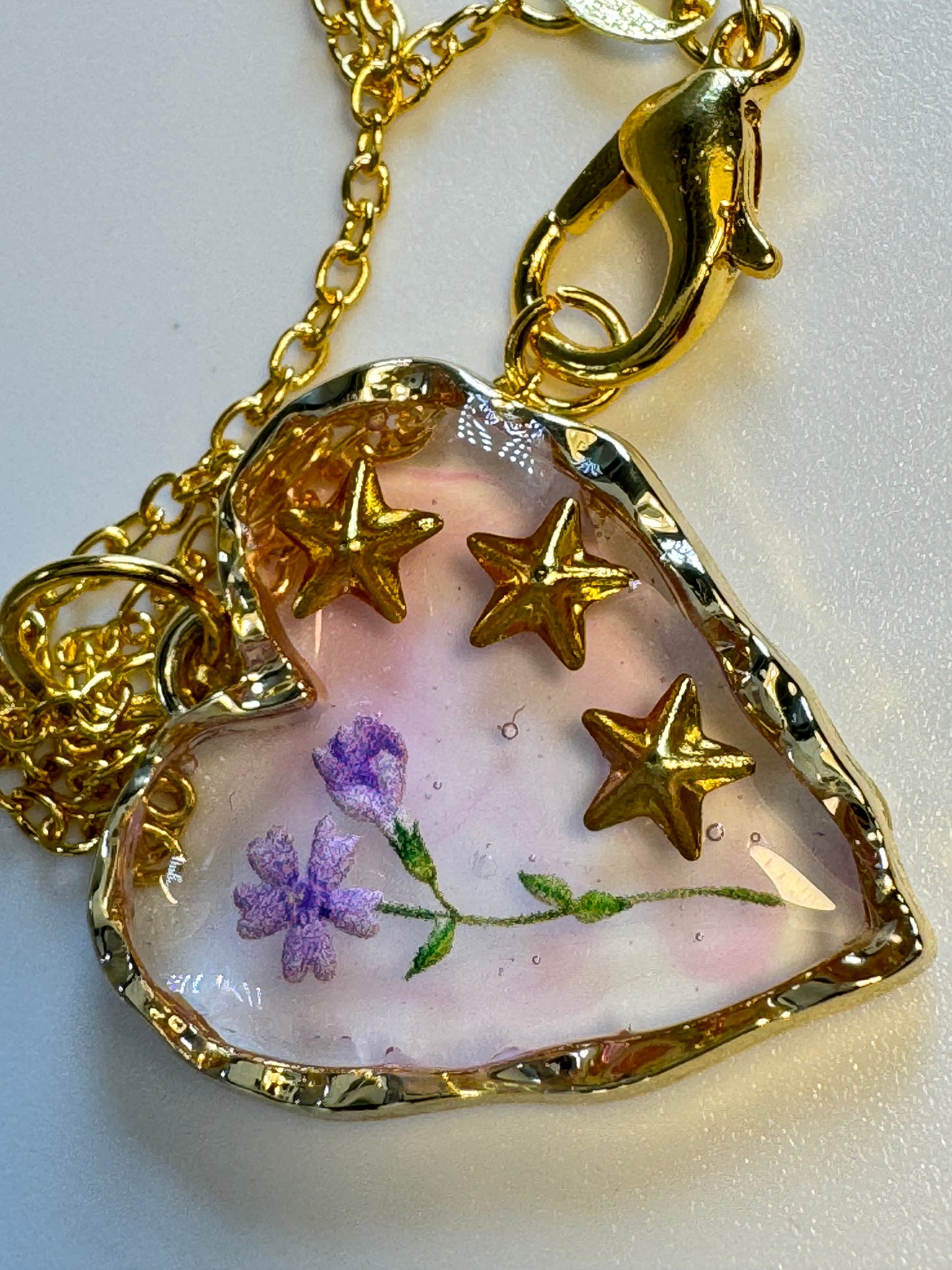 Heart Pendant with gold stars and lavender flower.