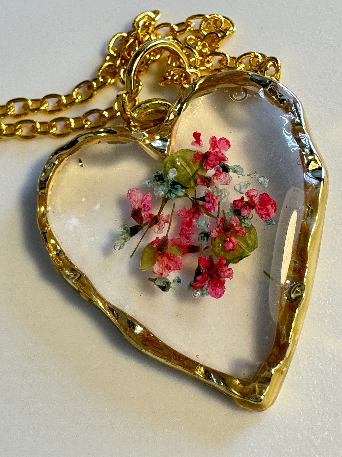 Heart Pendant with center designed flowers.