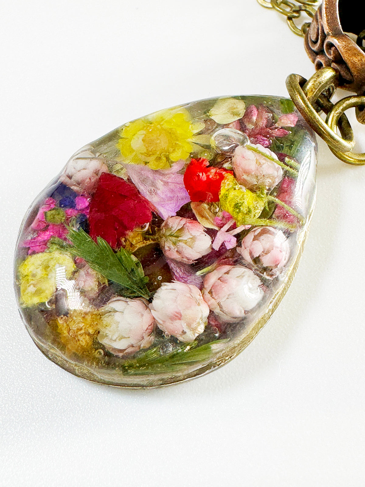 A "Garden in a Pendant" design with Brass Settings filled with Flowers