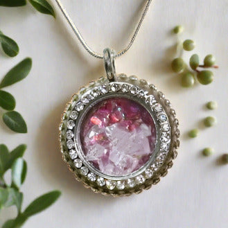 A Locket with a Red Flower background filled with sparkly Gems
