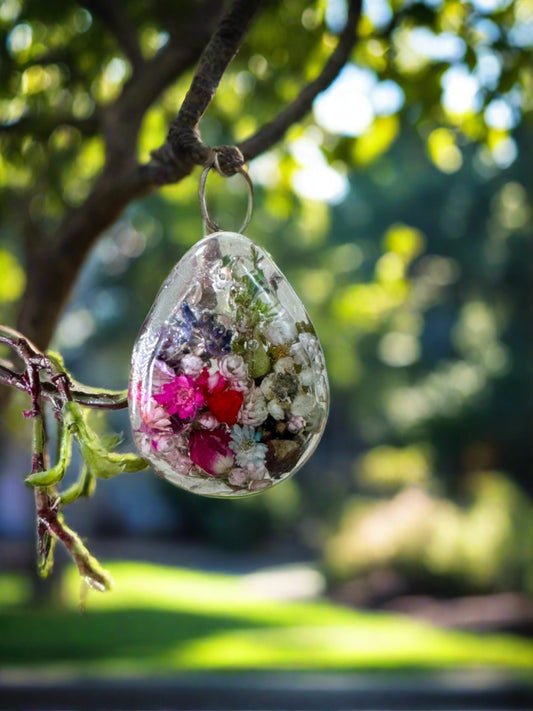 A "Garden in a Pendant" design with a garden inside the clear resin oval