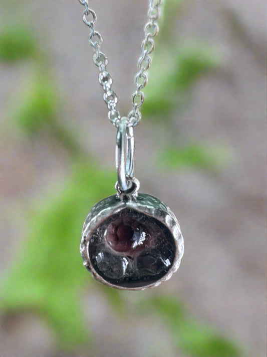 Black Pendant with Hammered Silver Setting and Purple Charm