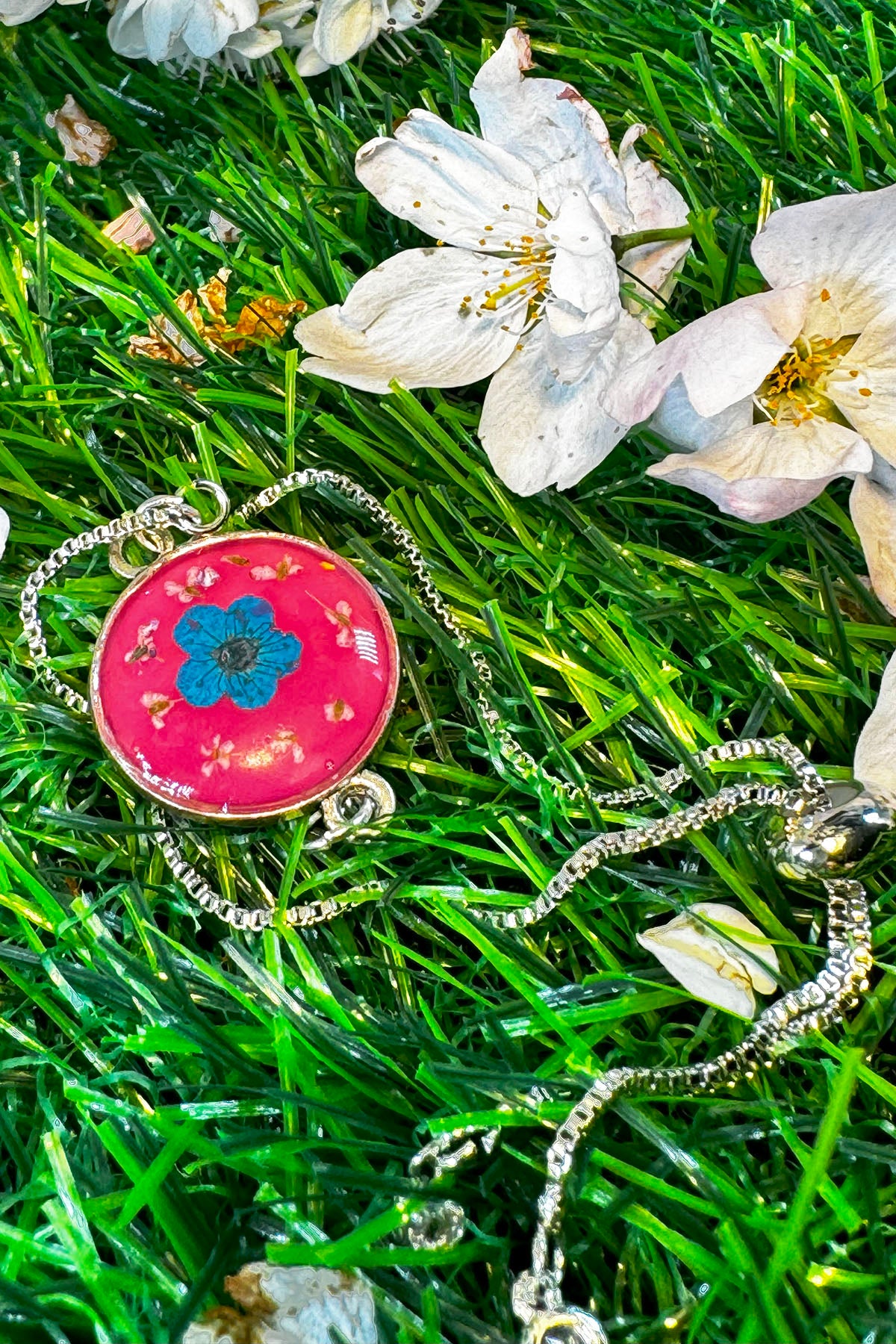 Red Bracelet with a Blue " Forget Me Not" in Silver